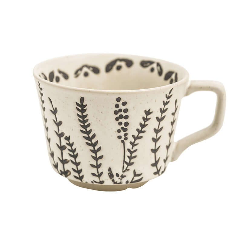 Hand-painted Minimalist Nordic ceramic mug featuring botanical designs in black on white porcelain.