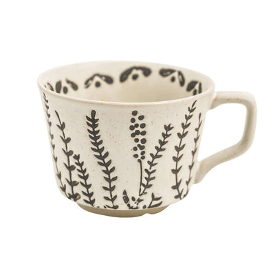 Hand-painted Minimalist Nordic ceramic mug featuring botanical designs in black on white porcelain.