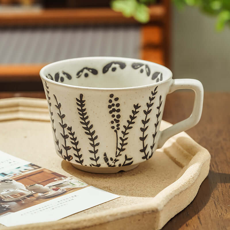 Hand-painted minimalist Nordic ceramic mug with floral design, perfect for modern home decor.