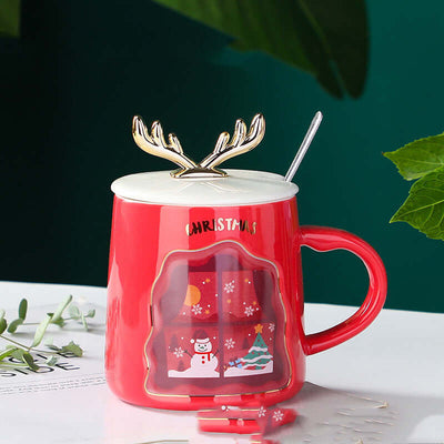 Red Christmas mug with antler lid and snowman design for festive drinks, includes spoon, perfect holiday gift.