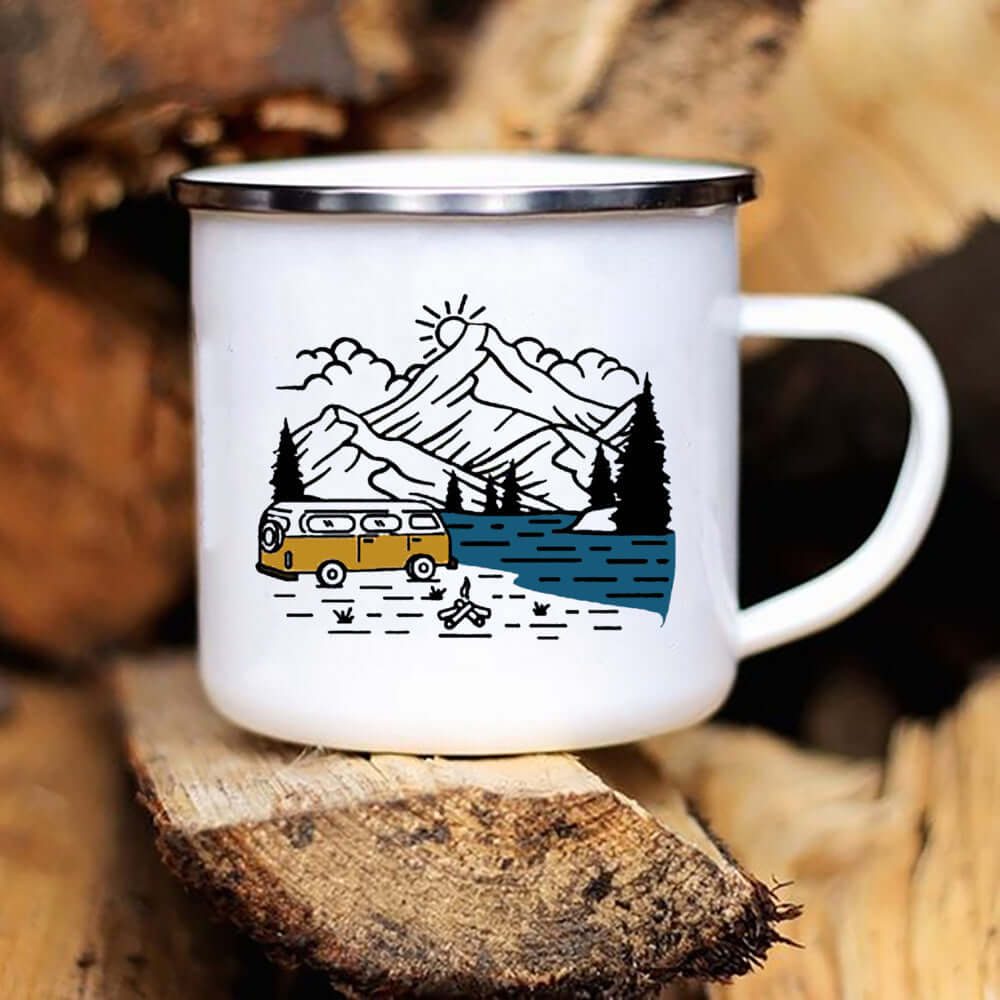 Ceramic camping enamel mug featuring a mountain scene, camper van, and river, perfect for outdoor adventures.