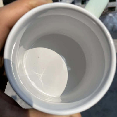 Interior view of a stoneware porcelain mug with a smooth white finish, showing ample space for drinks.